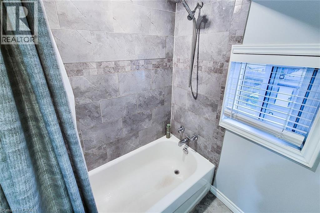Bathroom with shower / bath combo with shower curtain - 97 Keith Street, Hamilton, ON - Indoor Photo Showing Bathroom