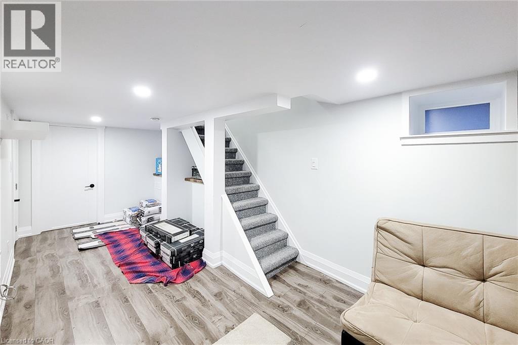 Finished basement featuring light wood-style floors and recessed lighting - 97 Keith Street, Hamilton, ON - Indoor
