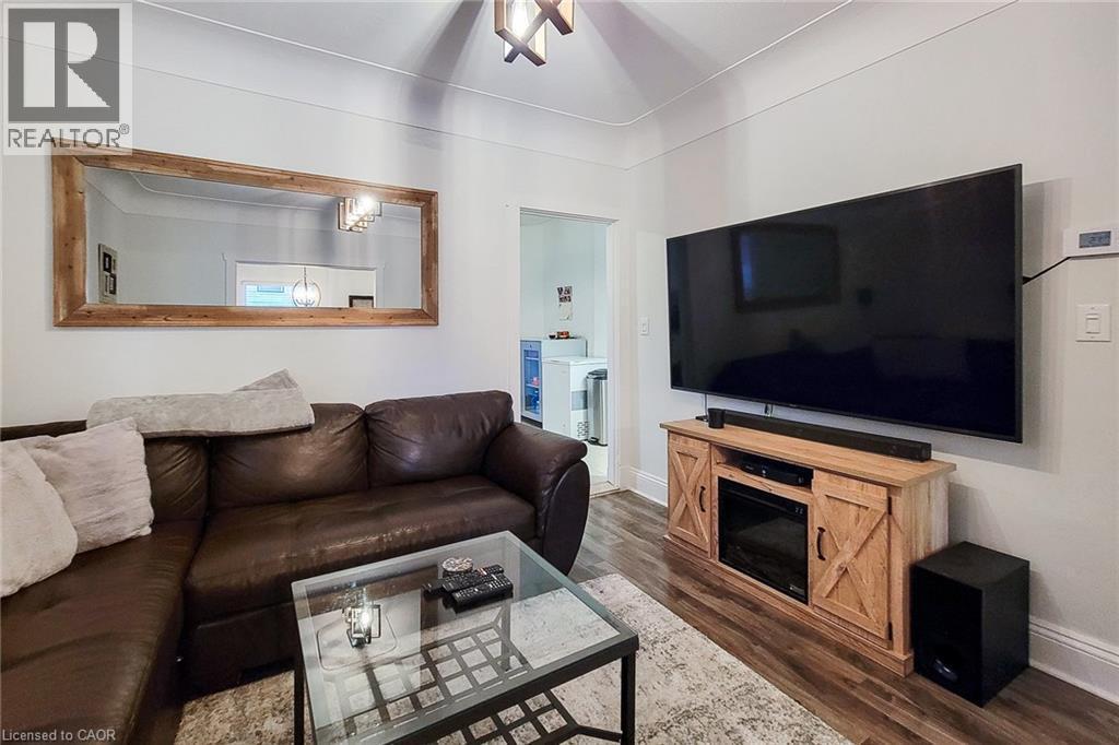 Living room with ceiling fan and dark wood-type flooring - 97 Keith Street, Hamilton, ON - Indoor Photo Showing Living Room