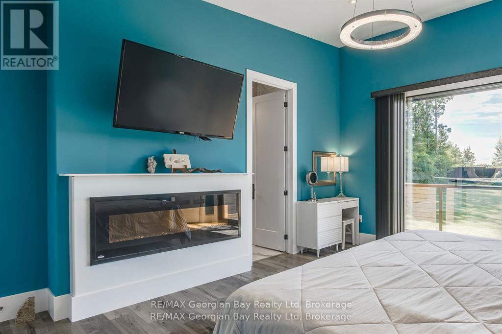 165 Wilson Road, Midland, ON - Indoor Photo Showing Bedroom With Fireplace