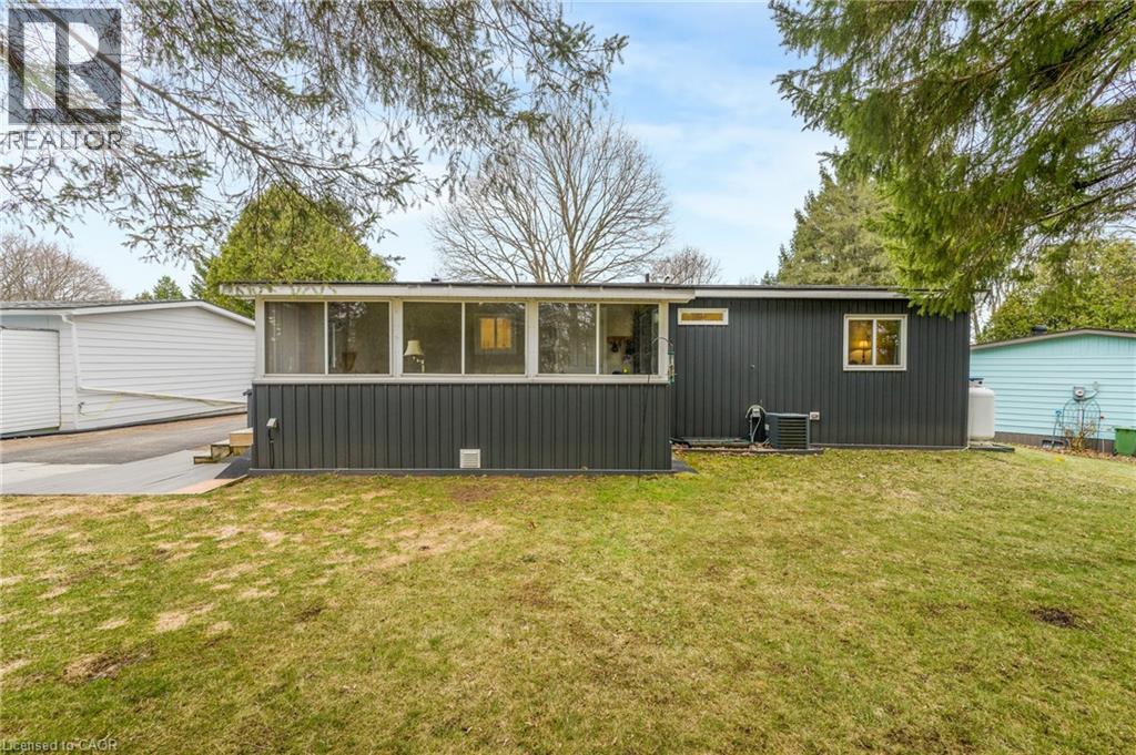 Back of house with a yard and a sunroom - 157 Maple Crescent, Hamilton, ON - Outdoor
