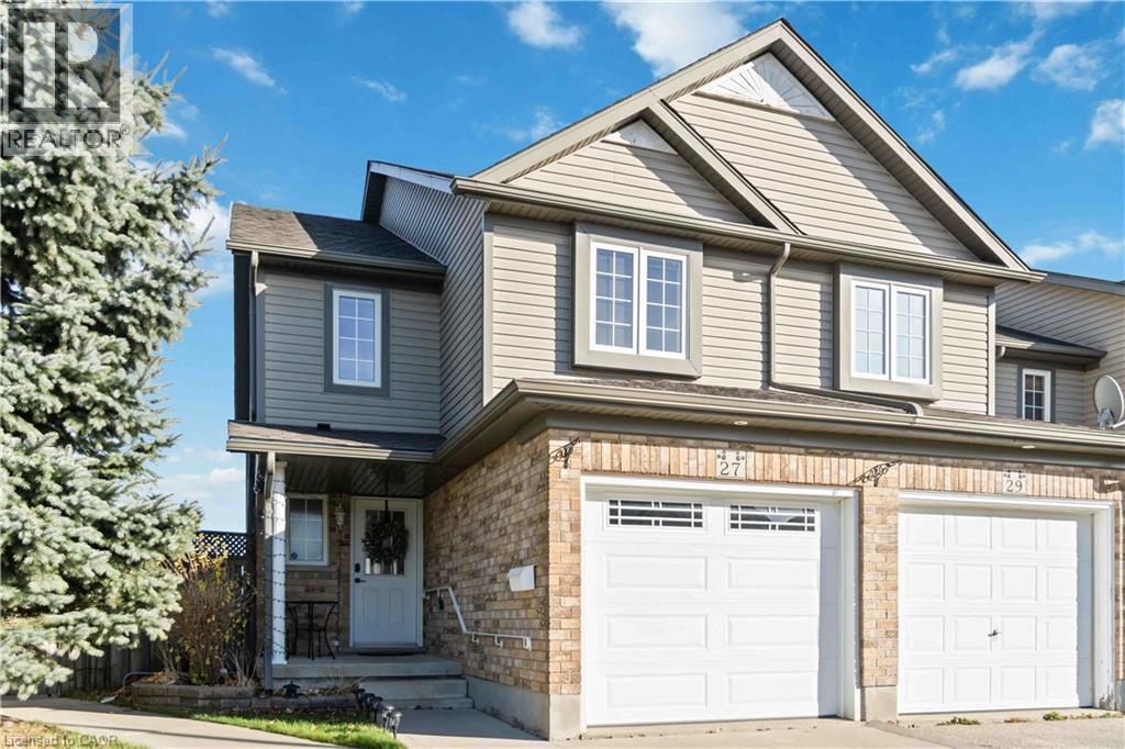 Traditional-style house featuring a garage, driveway, and a porch - 27 Red Clover Crescent, Kitchener, ON - Outdoor With Facade