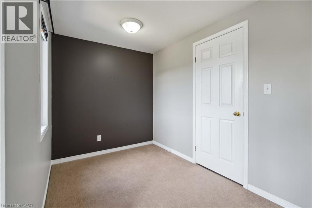 Empty room with light carpet and baseboards - 27 Red Clover Crescent, Kitchener, ON - Indoor Photo Showing Other Room