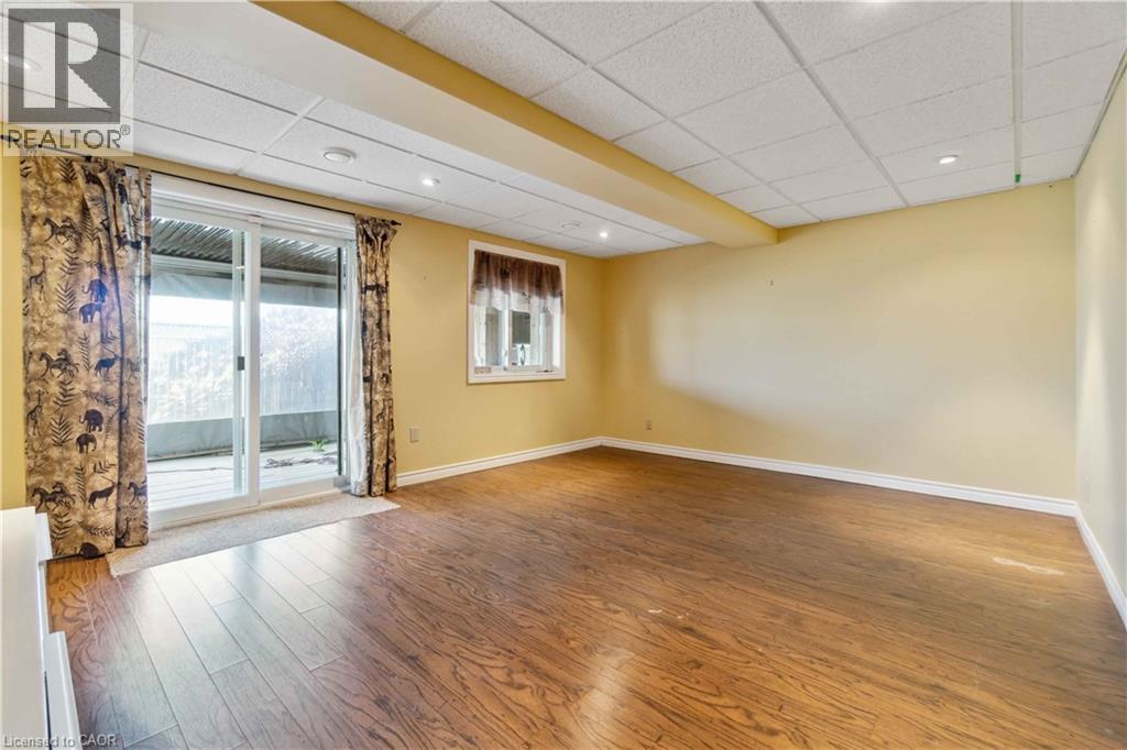 Unfurnished room featuring a paneled ceiling, wood finished floors, and recessed lighting - 27 Red Clover Crescent, Kitchener, ON - Indoor Photo Showing Other Room