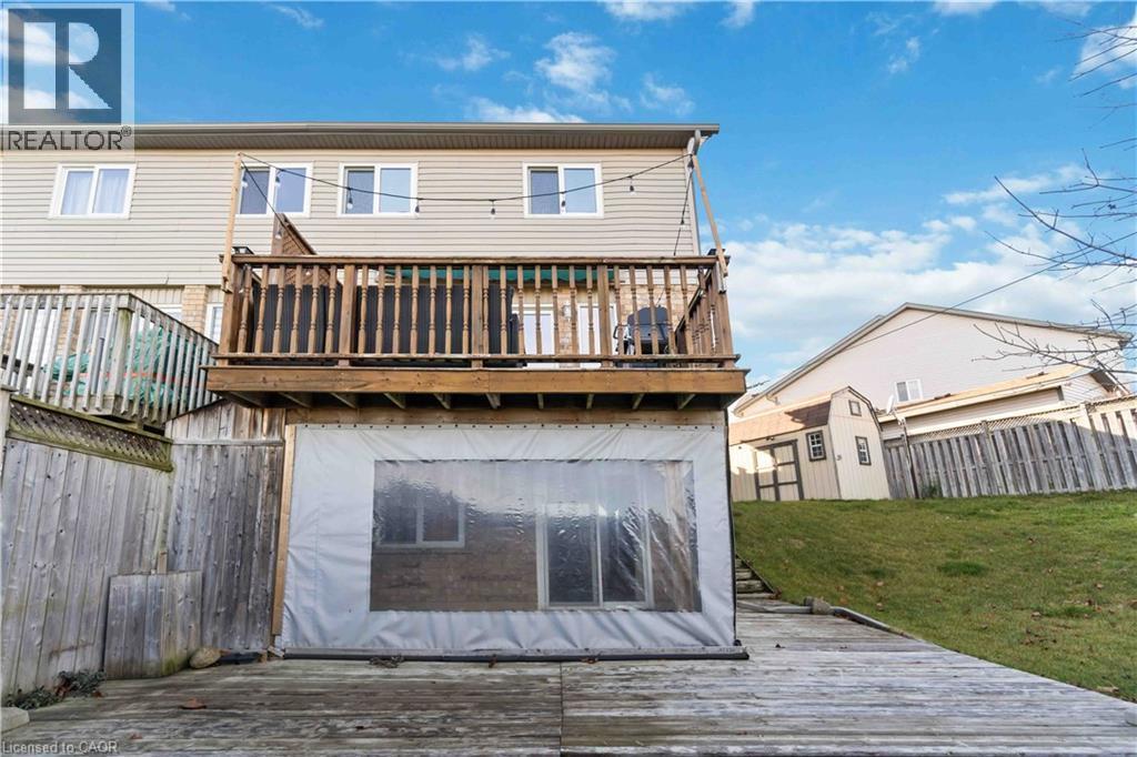 Back of property with a deck, a shed, and a fenced backyard - 27 Red Clover Crescent, Kitchener, ON - Outdoor With Deck Patio Veranda