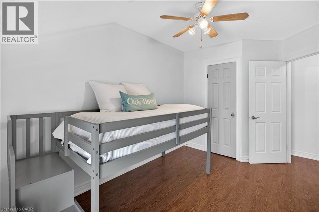 Bedroom featuring a ceiling fan, dark wood finished floors, and lofted ceiling - 216 Robert Street, Hamilton, ON - Indoor Photo Showing Bedroom