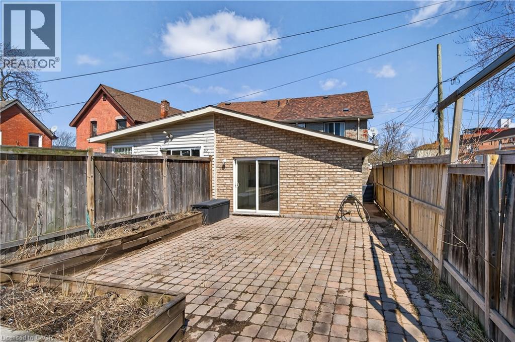 Fenced backyard featuring a patio area - 216 Robert Street, Hamilton, ON - Outdoor With Deck Patio Veranda