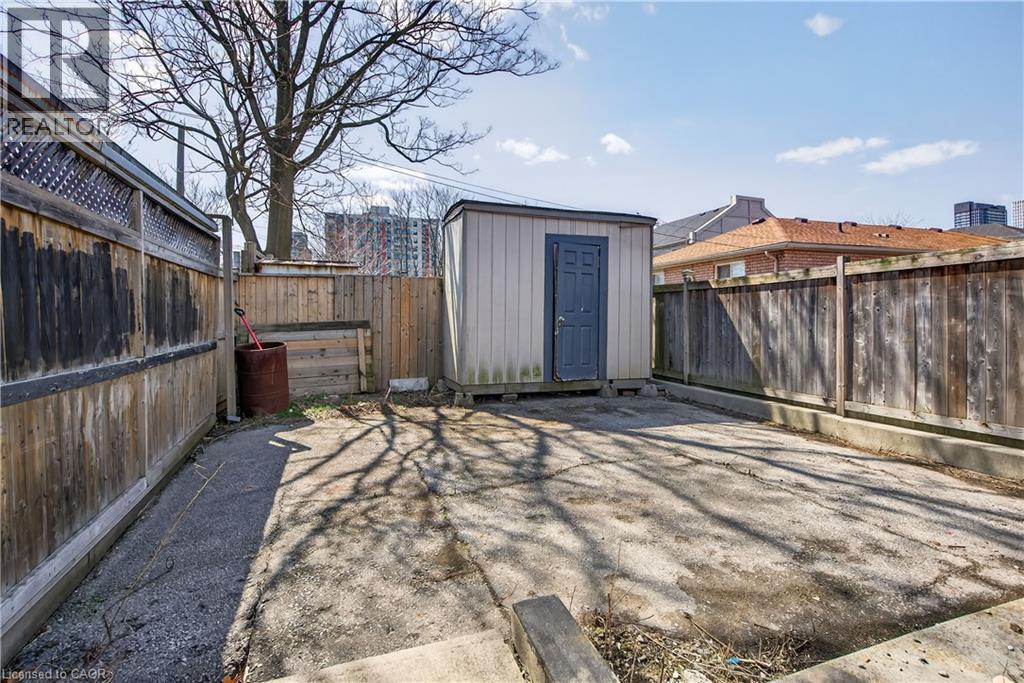 Fenced backyard with a storage shed - 216 Robert Street, Hamilton, ON - Outdoor