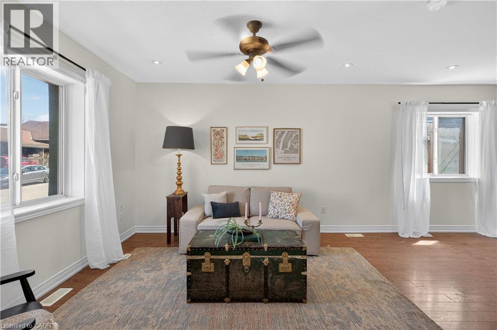 Living area with hardwood / wood-style flooring and ceiling fan - 216 Robert Street, Hamilton, ON - Indoor Photo Showing Living Room