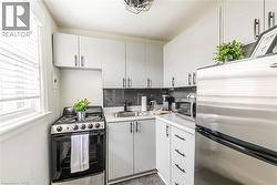 Kitchen with stainless steel appliances and light countertops -