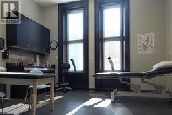 Exercise area featuring baseboards and a high ceiling -