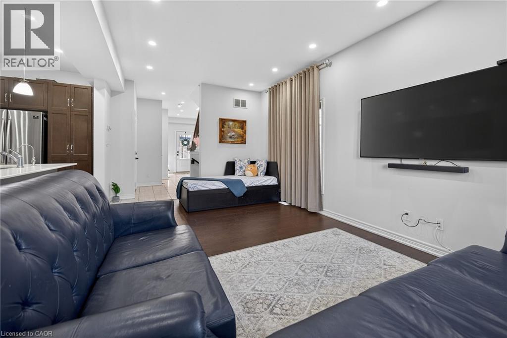 Living room with dark wood-style flooring and recessed lighting - 80 Severino Circle, Smithville, ON - Indoor Photo Showing Living Room