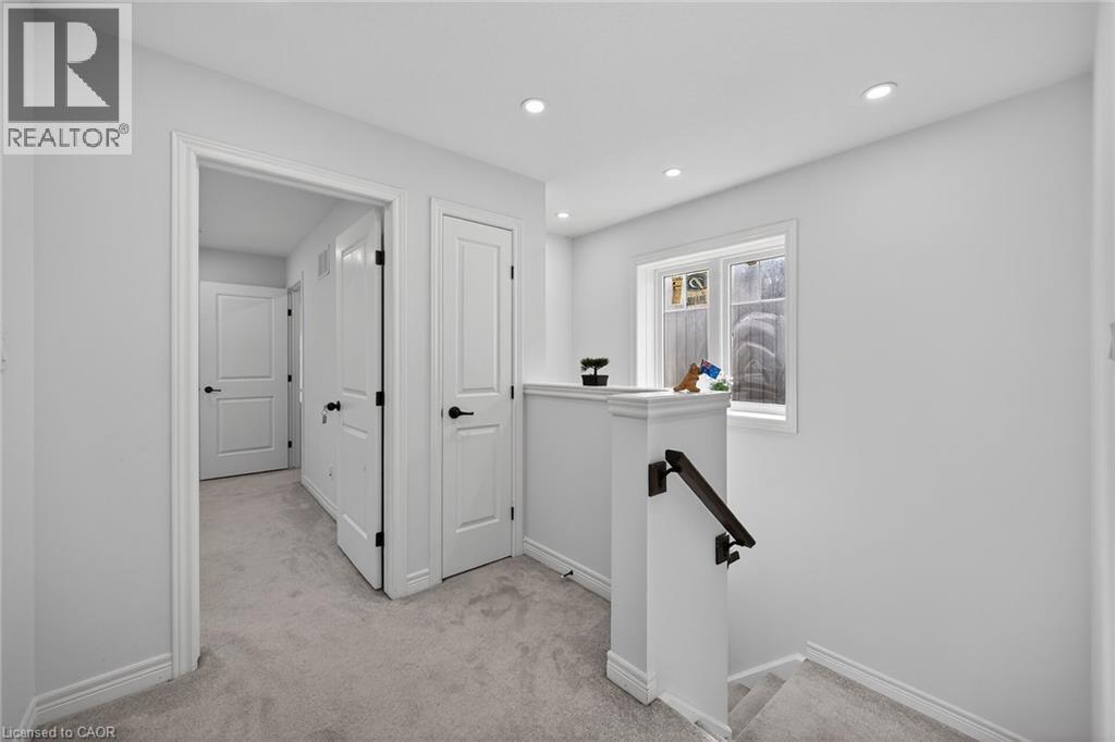 Corridor with an upstairs landing, light colored carpet, and recessed lighting - 80 Severino Circle, Smithville, ON - Indoor Photo Showing Other Room