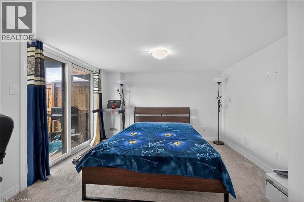 Bedroom with light colored carpet and access to outside - 80 Severino Circle, Smithville, ON - Indoor Photo Showing Bedroom