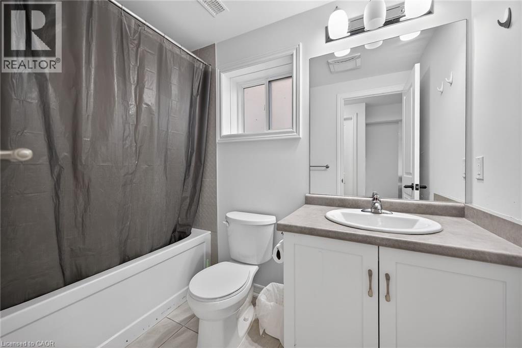Full bath with vanity, shower / tub combo with curtain, and light tile patterned floors - 80 Severino Circle, Smithville, ON - Indoor Photo Showing Bathroom