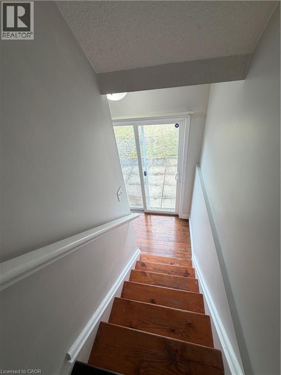 Stairway with a textured ceiling and wood finished floors - 45 Brookfield Crescent, Kitchener, ON - Indoor Photo Showing Other Room