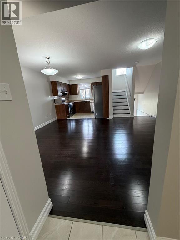 Unfurnished living room featuring baseboards and dark wood finished floors - 45 Brookfield Crescent, Kitchener, ON - Indoor Photo Showing Other Room