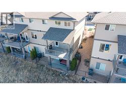 View from back with private covered deck and compact private yard -