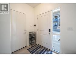 Foyer with front door and door to garage -