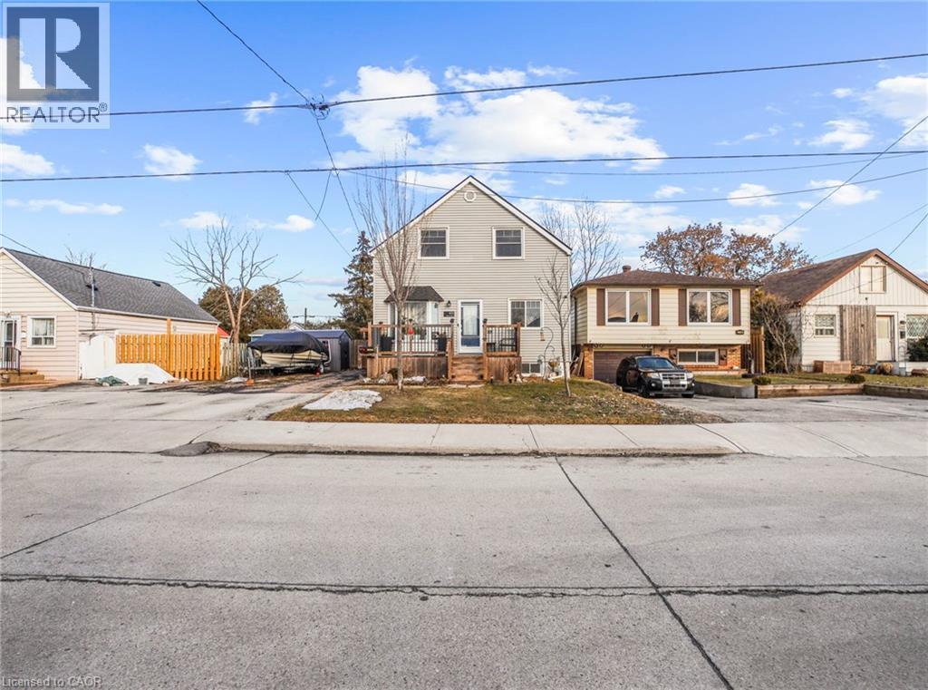 View of front facade with a wooden deck and driveway - 420 Waverly Street, Hamilton, ON - Outdoor