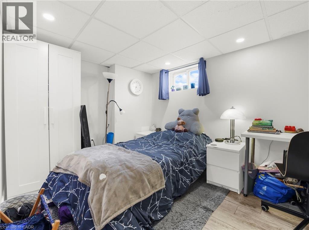 Bedroom featuring a paneled ceiling, light wood finished floors, and recessed lighting - 420 Waverly Street, Hamilton, ON - Indoor Photo Showing Bedroom