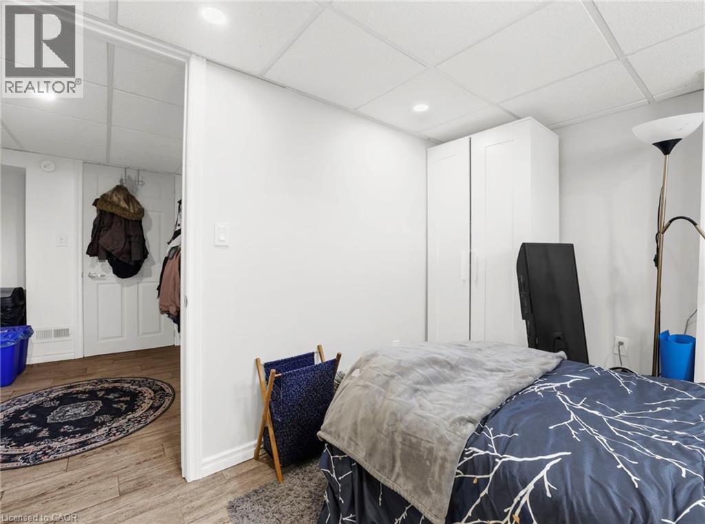 Bedroom with a drop ceiling, light wood-style flooring, and recessed lighting - 420 Waverly Street, Hamilton, ON - Indoor Photo Showing Bedroom