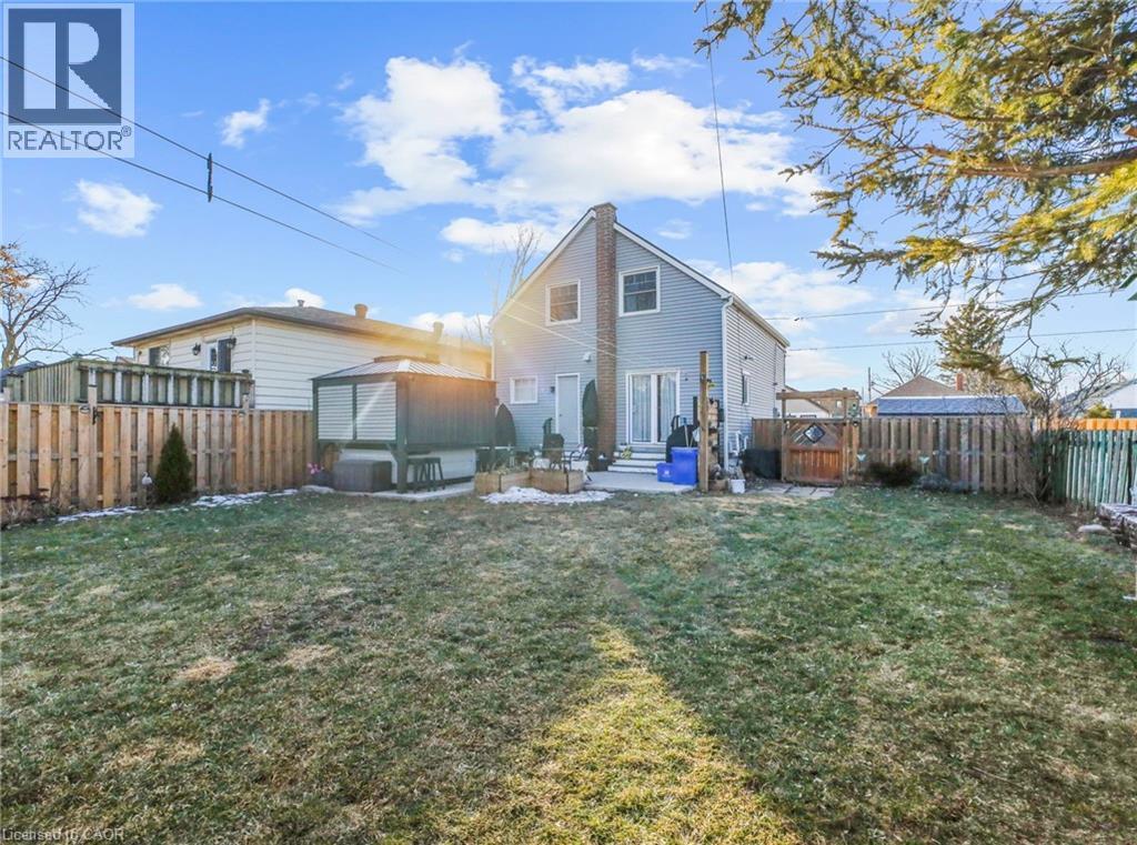 Back of property featuring a patio area, a fenced backyard, a chimney, and entry steps - 420 Waverly Street, Hamilton, ON - Outdoor