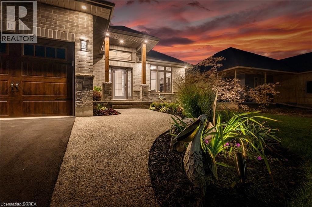View of front of home with stone siding and driveway - 11 Sycamore Drive, Port Dover, ON - Outdoor