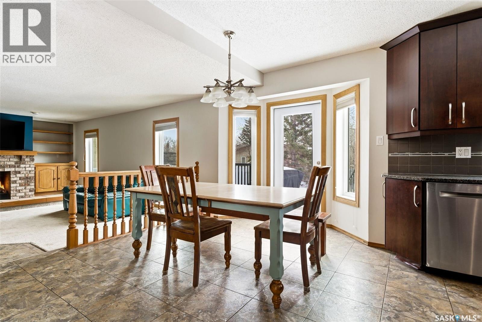 3242 Barton Place E, Regina, SK - Indoor Photo Showing Dining Room With Fireplace