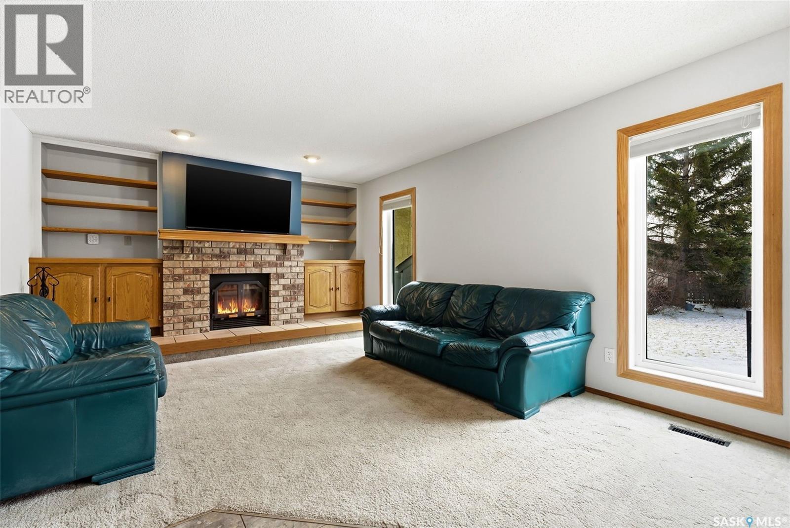 3242 Barton Place E, Regina, SK - Indoor Photo Showing Living Room With Fireplace