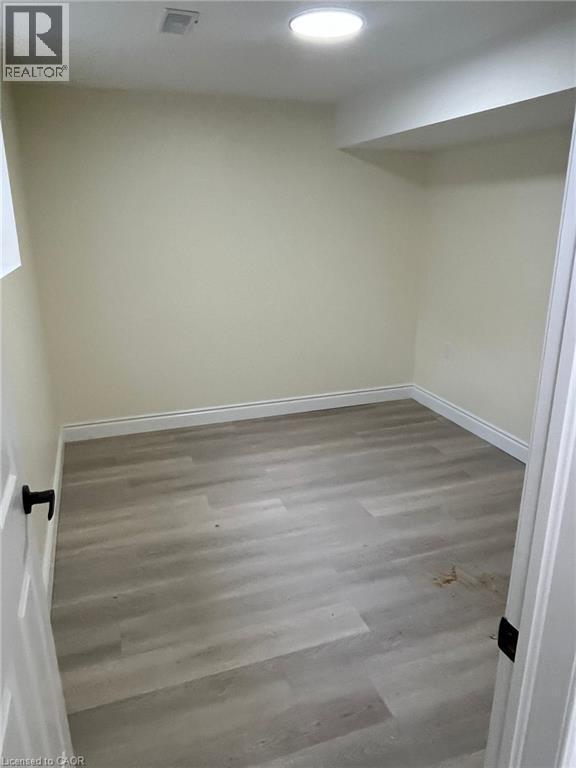 Unfurnished room with wood finished floors and baseboards - 59 Windrush Trail S Unit# B, Kitchener, ON - Indoor Photo Showing Other Room