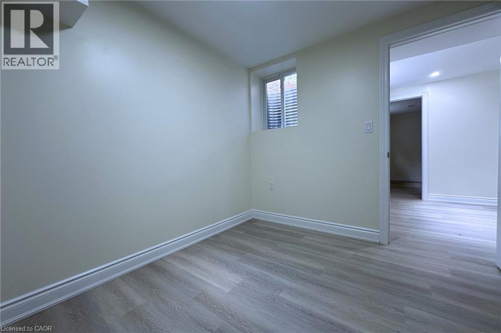 Spare room with dark wood-style flooring and baseboards - 59 Windrush Trail S Unit# B, Kitchener, ON - Indoor Photo Showing Other Room