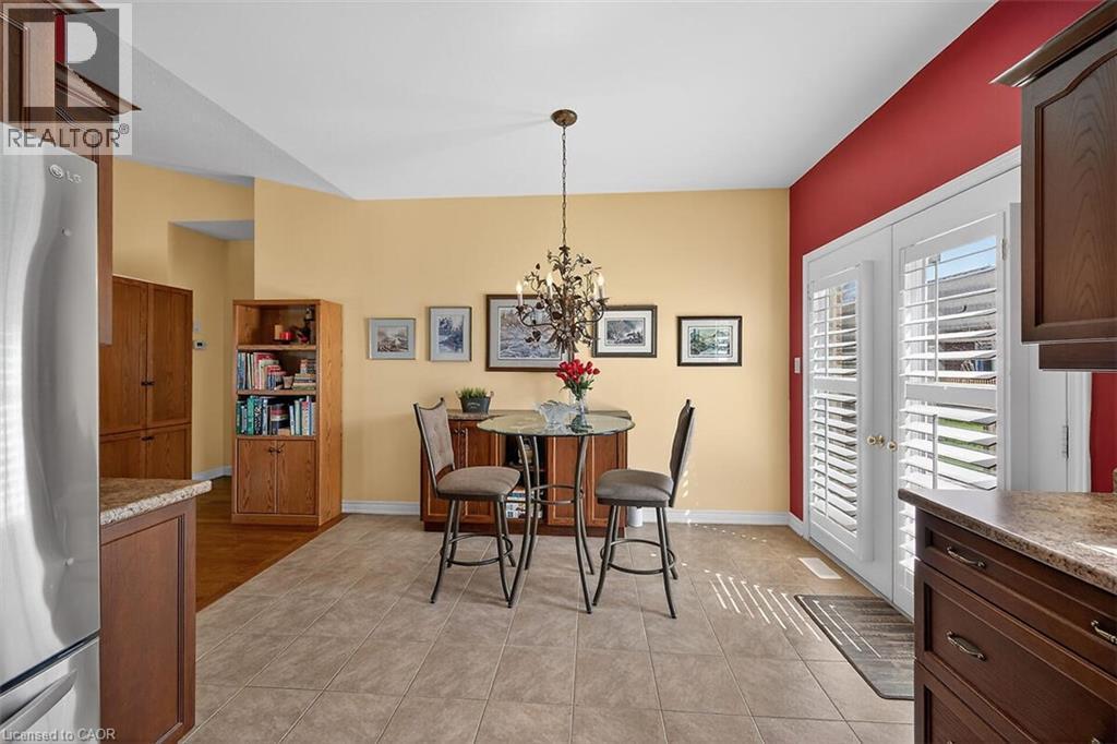 Dining area featuring hanging lights and light tile patterned floors - 48 Hallmark Trail, Hamilton, ON - Indoor Photo Showing Other Room