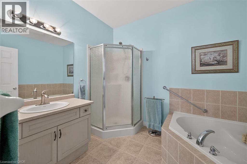 Bathroom featuring vanity, a garden tub, a shower stall, and light tile patterned flooring - 48 Hallmark Trail, Hamilton, ON - Indoor Photo Showing Bathroom
