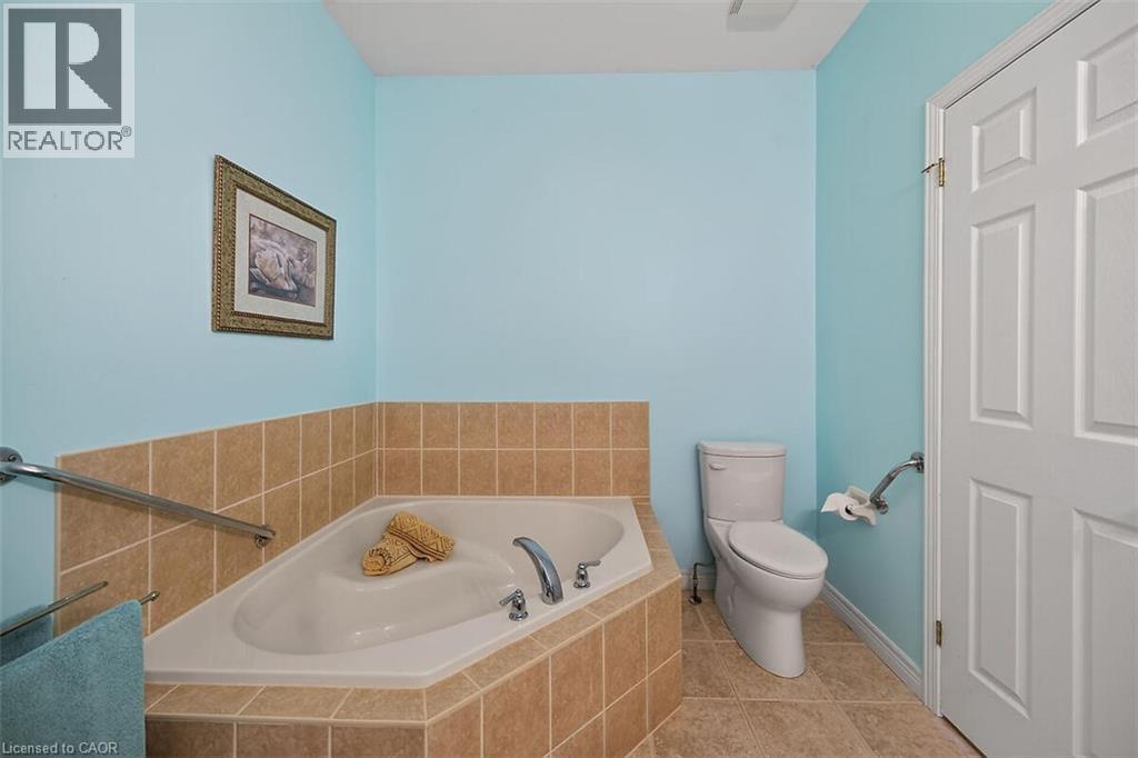 Full bath with a garden tub and light tile patterned flooring - 48 Hallmark Trail, Hamilton, ON - Indoor Photo Showing Bathroom