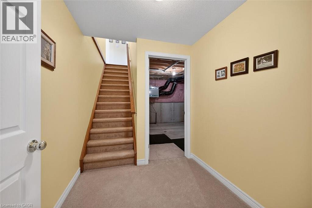 Stairs featuring carpet floors and a textured ceiling - 48 Hallmark Trail, Hamilton, ON - Indoor Photo Showing Other Room