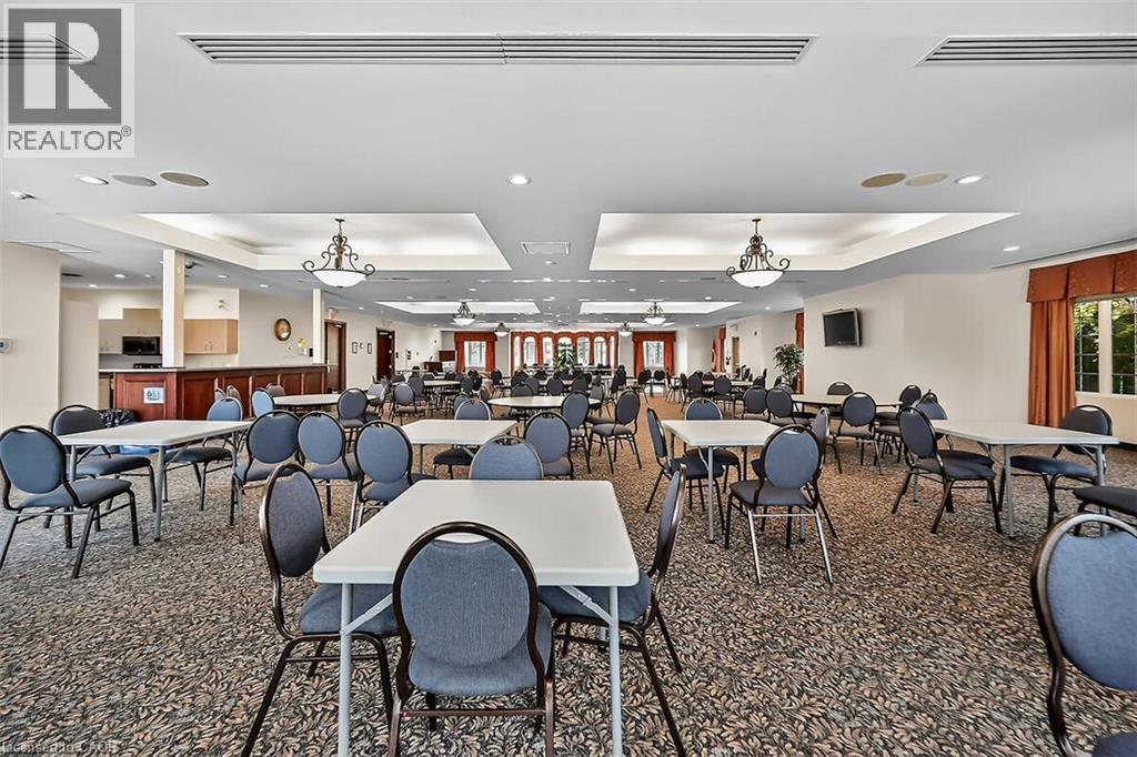 Carpeted dining room with a tray ceiling and recessed lighting - 48 Hallmark Trail, Hamilton, ON - Indoor
