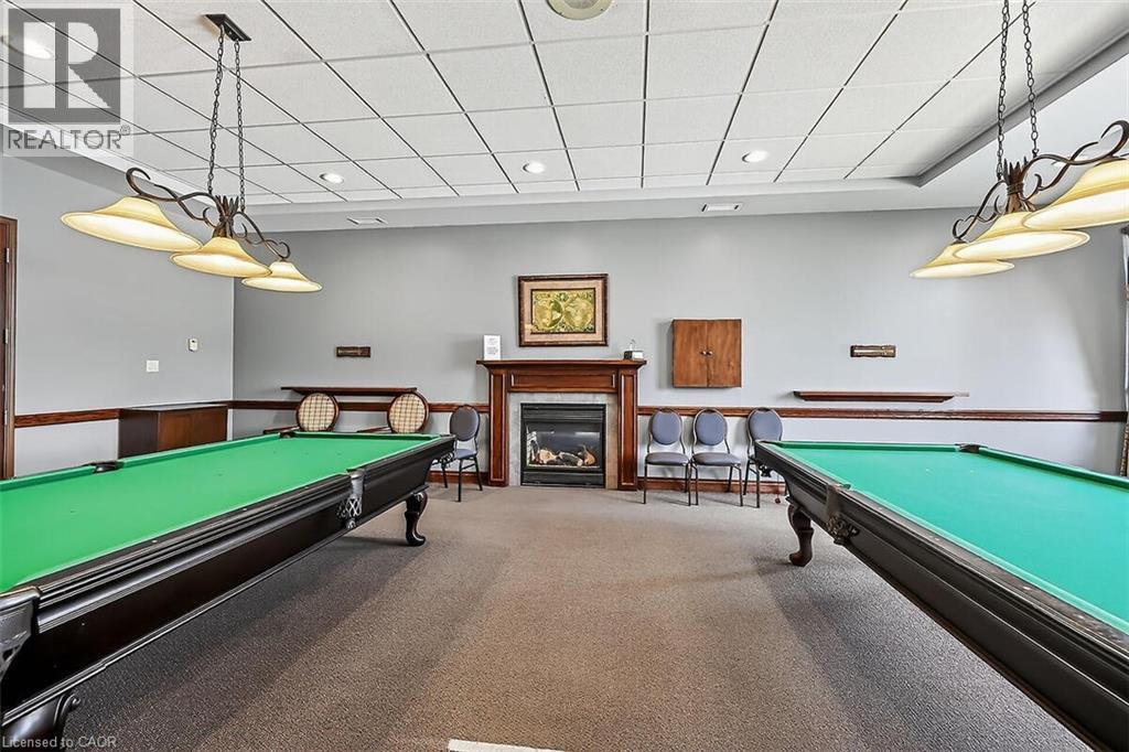 Recreation room with pool table, a glass covered fireplace, and a drop ceiling - 48 Hallmark Trail, Hamilton, ON - Indoor Photo Showing Other Room