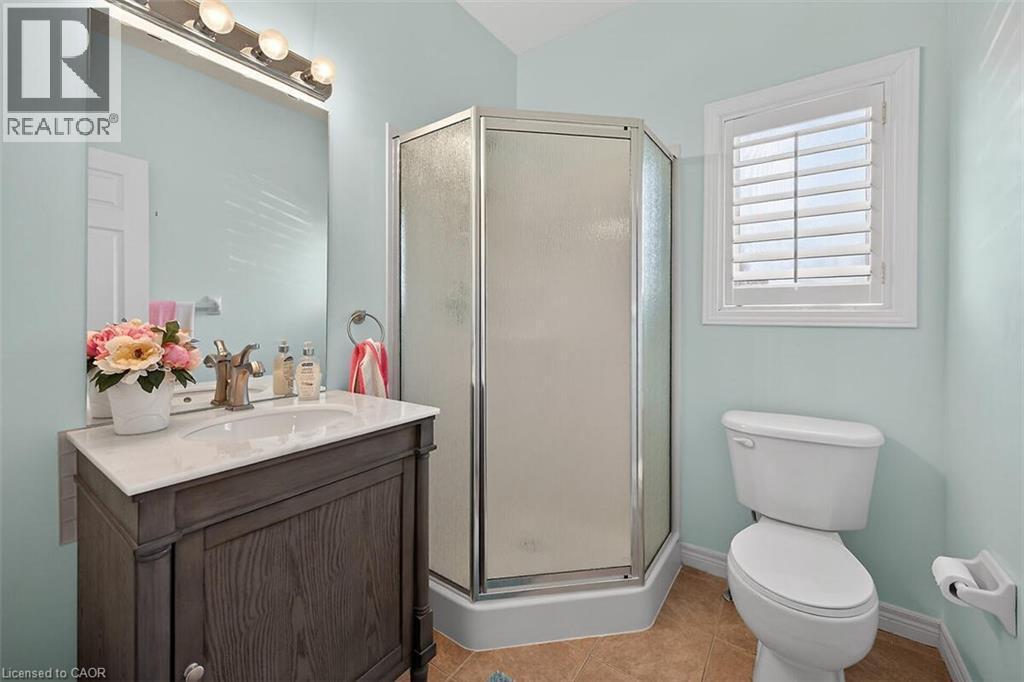 Bathroom featuring vanity, a stall shower, and light tile patterned floors - 48 Hallmark Trail, Hamilton, ON - Indoor Photo Showing Bathroom