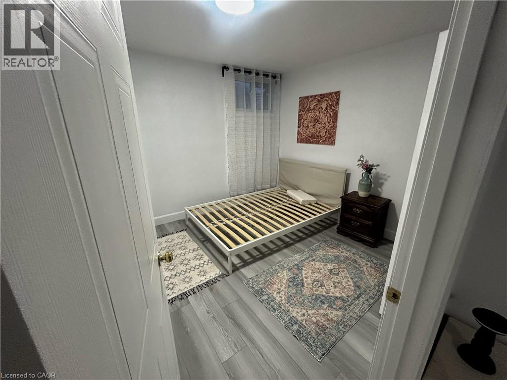 Bedroom with wood finished floors and baseboards - 206A Springfield Crescent Unit# Lower, Waterloo, ON - Indoor Photo Showing Other Room