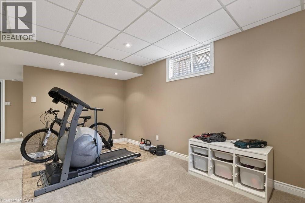 with gym setup & rough in for wet bar - 39 Trenholme Crescent, Hamilton, ON - Indoor Photo Showing Gym Room