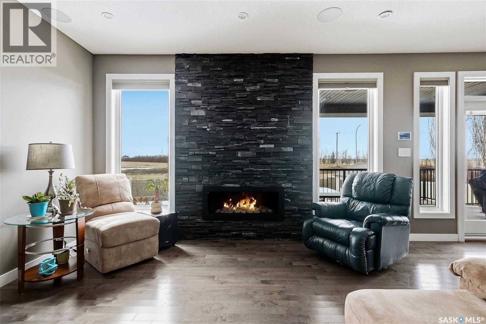 6040 Little Pine Loop, Regina, SK - Indoor Photo Showing Living Room With Fireplace