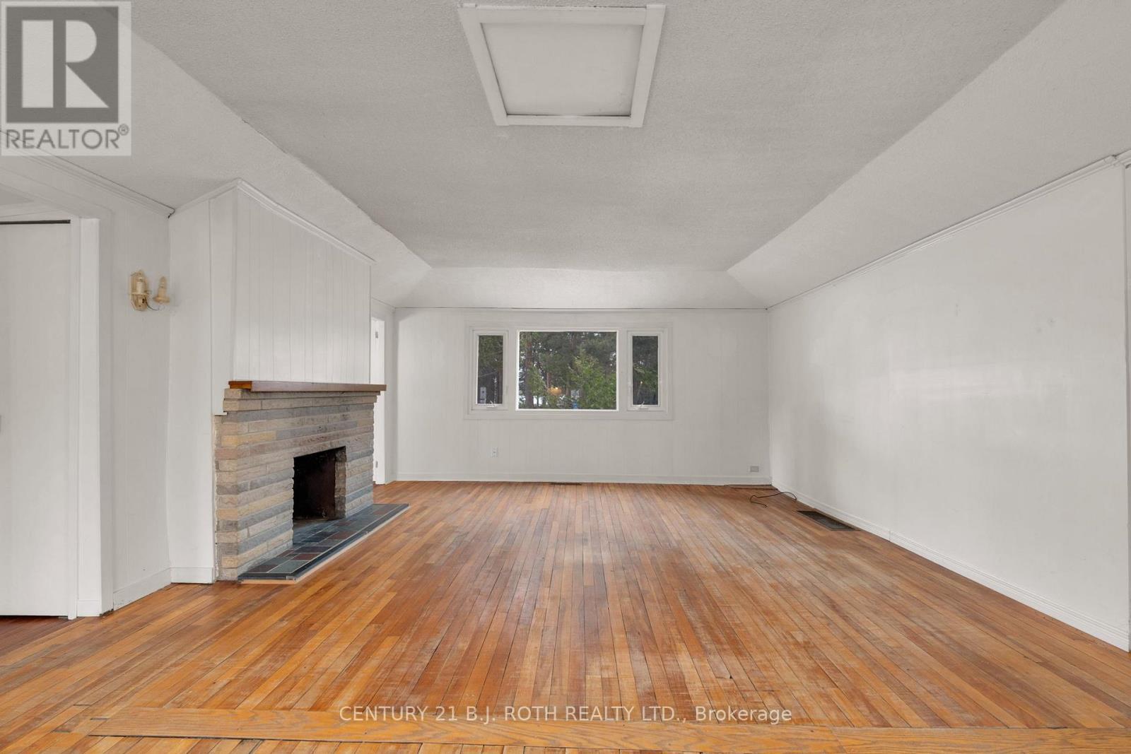 2026 Tiny Beaches Road S, Tiny, ON - Indoor Photo Showing Living Room With Fireplace
