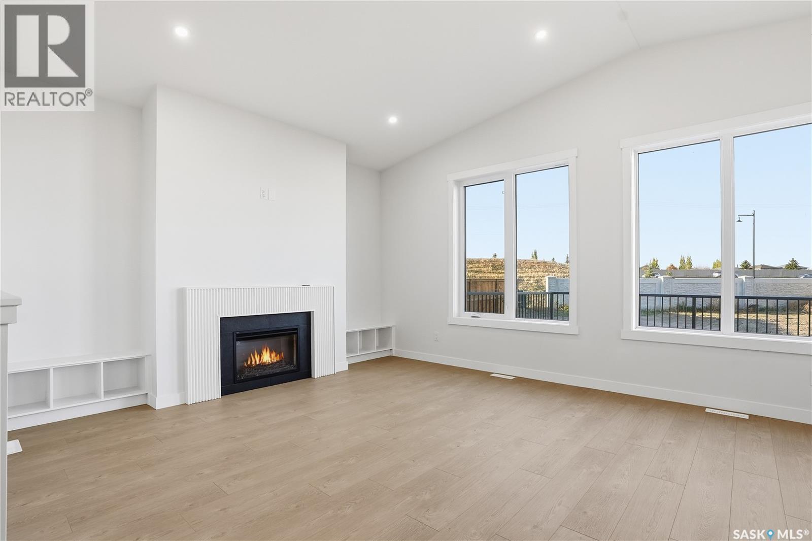 151 Nazarali Way, Saskatoon, SK - Indoor Photo Showing Living Room With Fireplace
