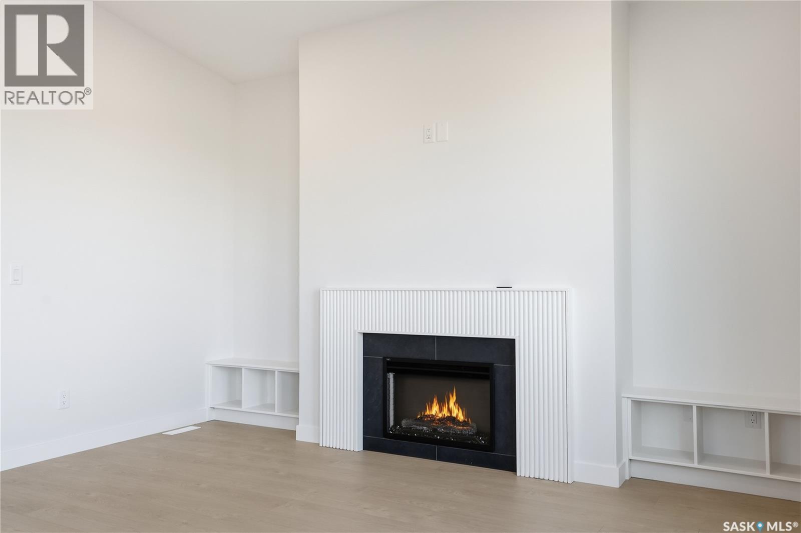 151 Nazarali Way, Saskatoon, SK - Indoor Photo Showing Living Room With Fireplace