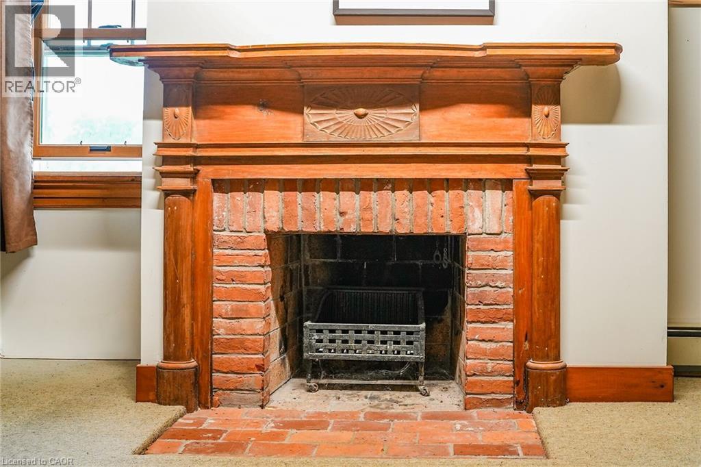 Detailed view of carpet and a fireplace - 2432 Seburn Road, Fonthill, ON - Indoor Photo Showing Other Room With Fireplace