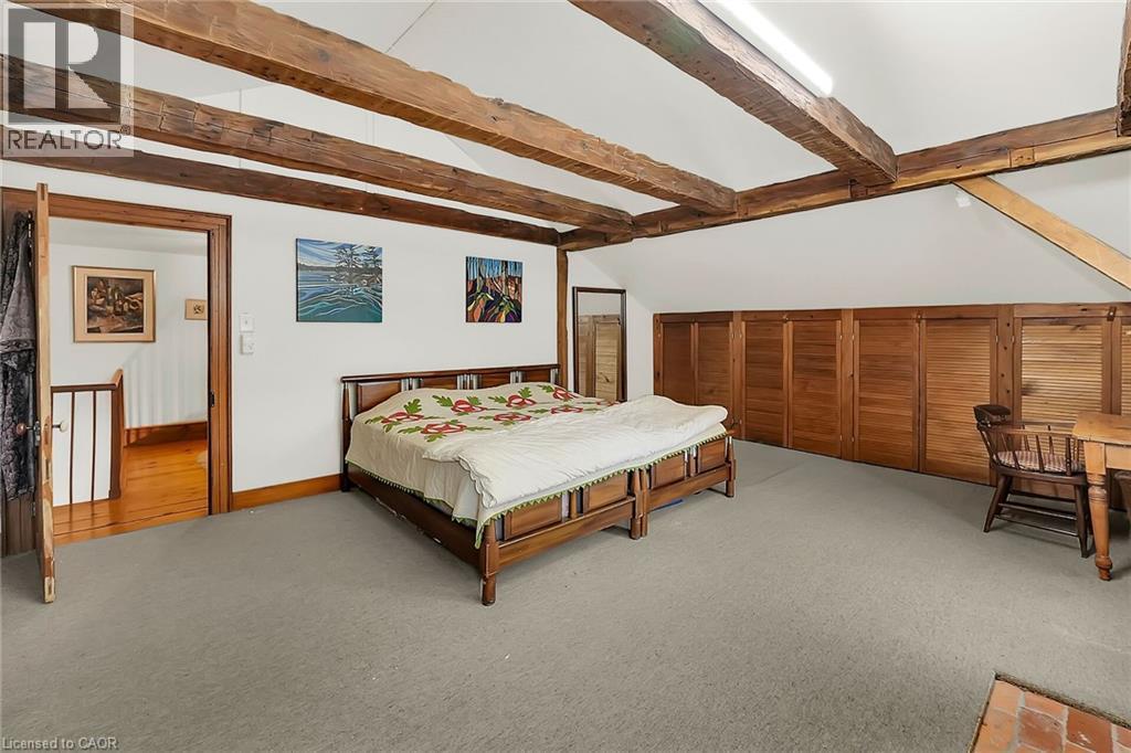 Bedroom with light carpet and vaulted ceiling with beams - 2432 Seburn Road, Fonthill, ON - Indoor