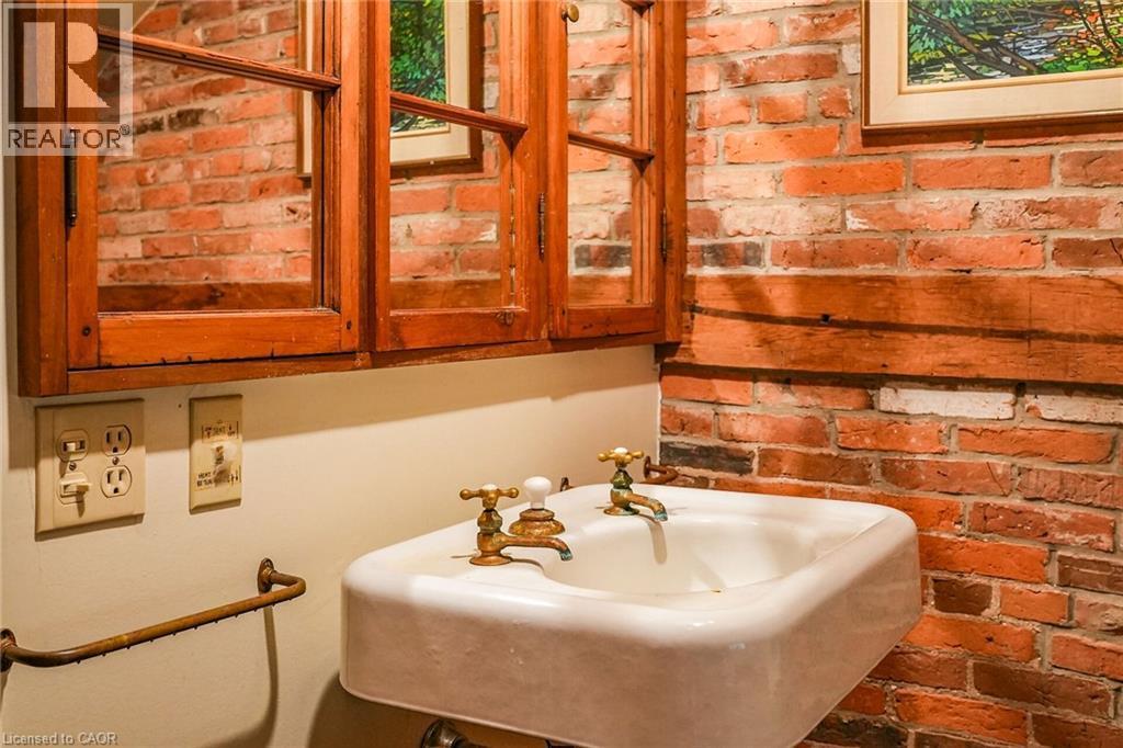 Bathroom with brick wall and a sink - 2432 Seburn Road, Fonthill, ON - Indoor Photo Showing Bathroom