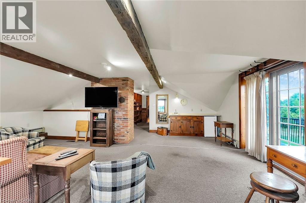 Living area featuring light colored carpet and vaulted ceiling - 2432 Seburn Road, Fonthill, ON - Indoor