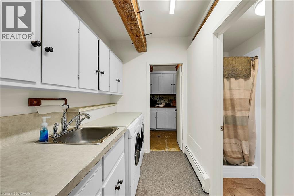 Laundry area featuring a baseboard heating unit and a sink - 2432 Seburn Road, Fonthill, ON - Indoor Photo Showing Kitchen